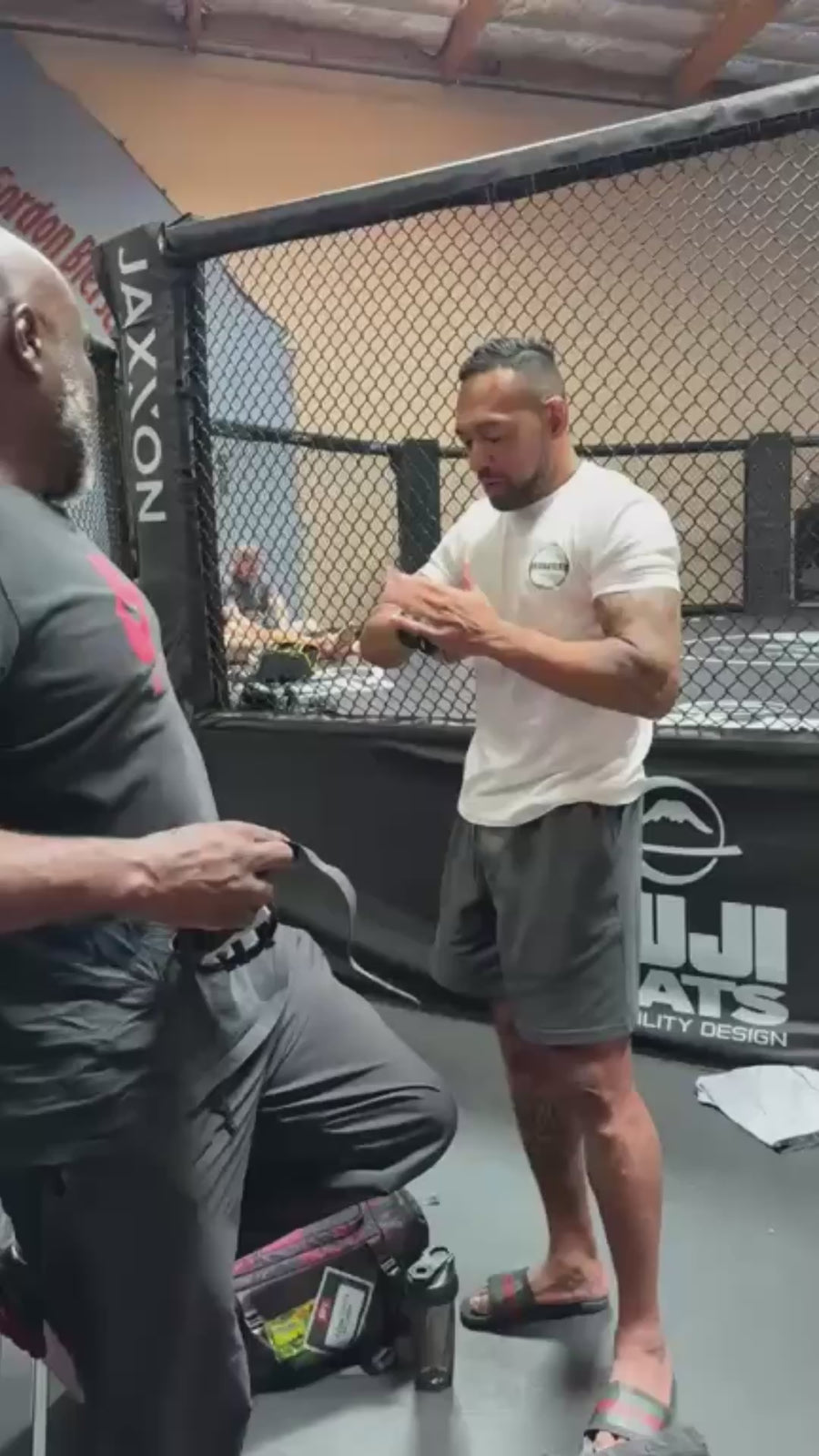 Tate Wrap demonstration beside an MMA cage
